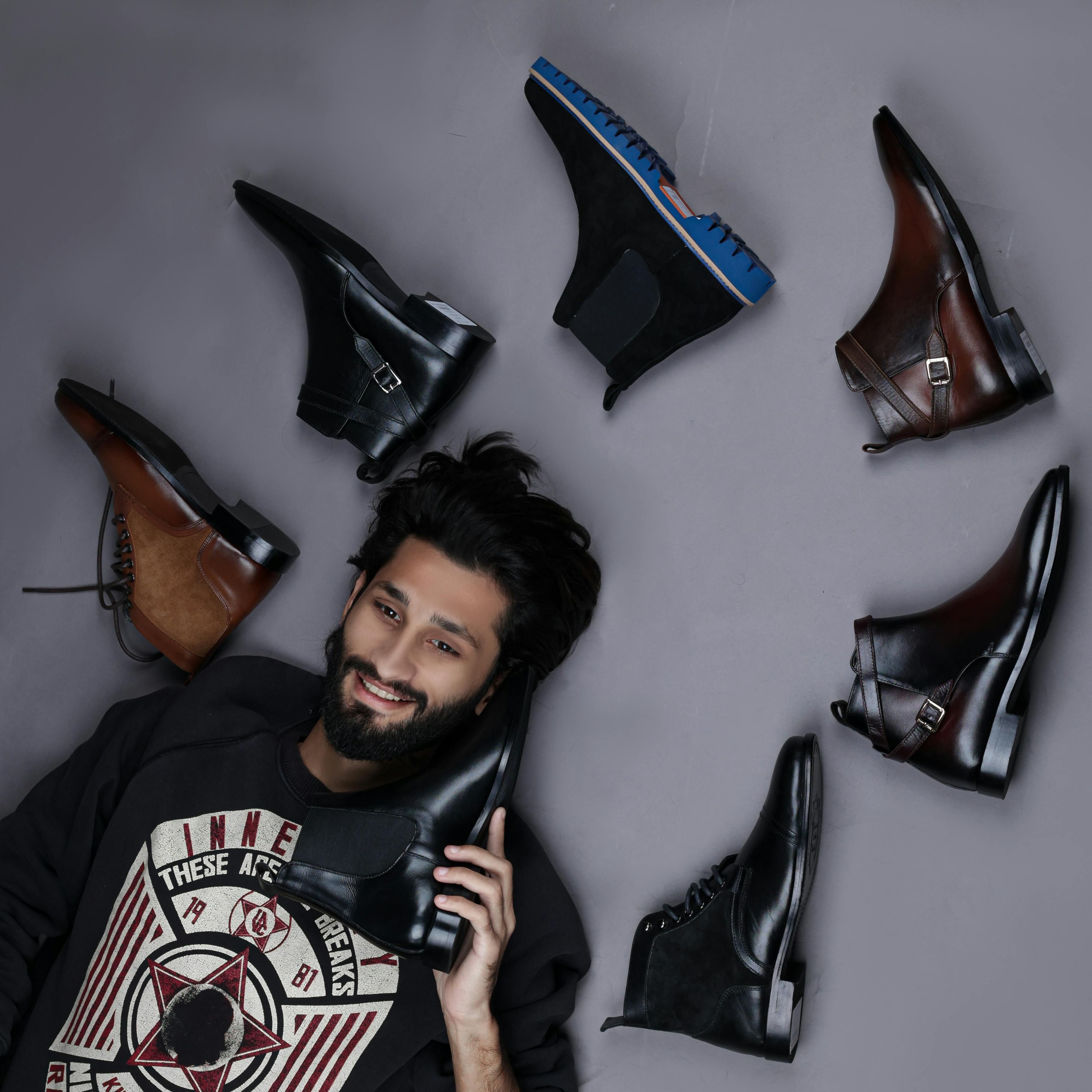 men laying on the floor, surrounded by shoes